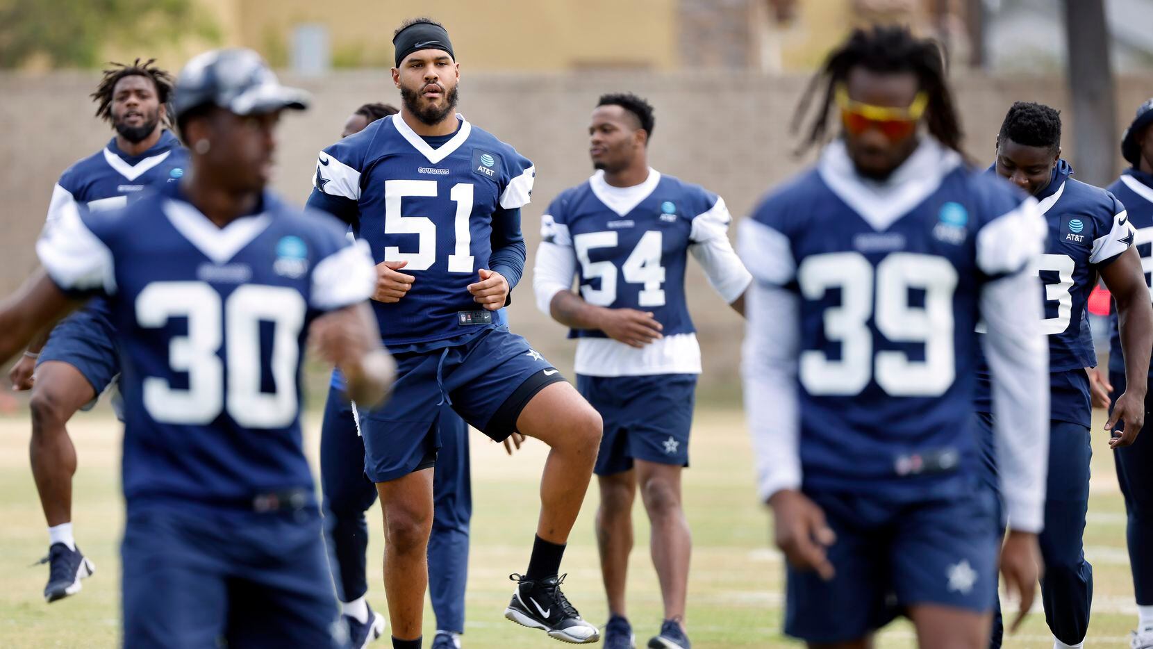 New Dallas Cowboys linebacker Anthony Barr (51) stretches with teammates during the NFL...