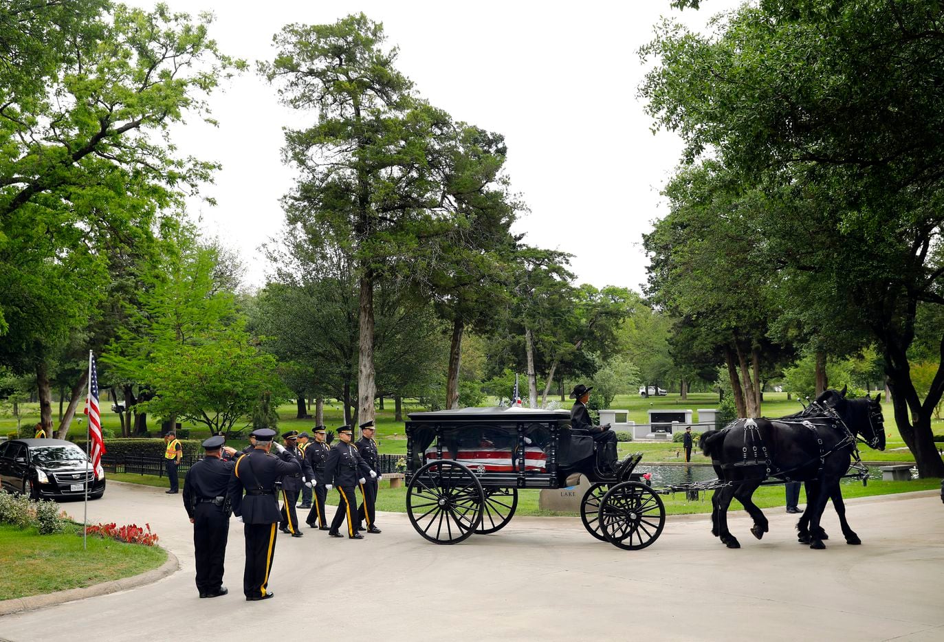 The Dallas Police Honor Guard escorts the horse-drawn carriage carrying slain Dallas police...
