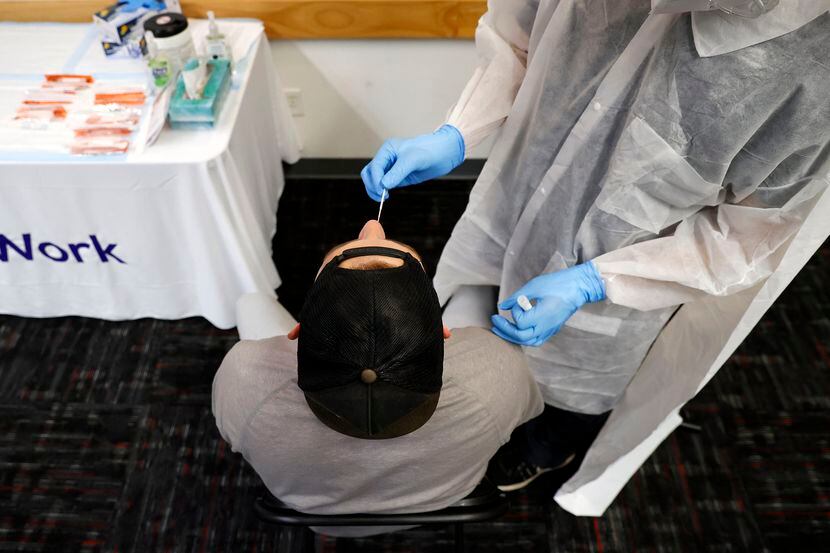 A Dallas Police officer is tested for COVID-19 by SafeWork medical assistant Angel Nunez at...