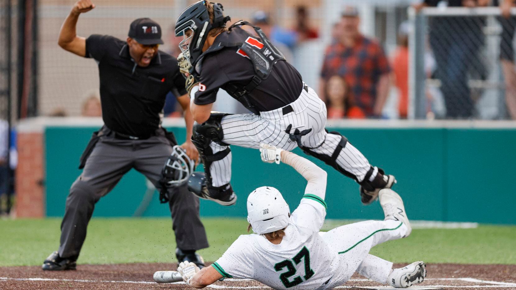 Waxahachie designated hitter Chase Pope (27) collides with Rockwall catcher Jake Overstreet...