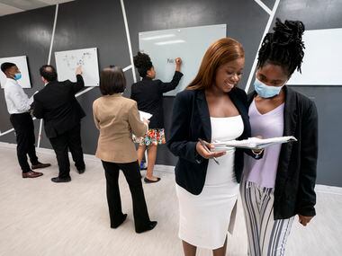 Tatu Magahura, left, an account executive at Lumos Marketing Group, participate in a training exercise with corporate trainer Delisa Sanders on Aug. 16 at its offices in Far North Dallas.