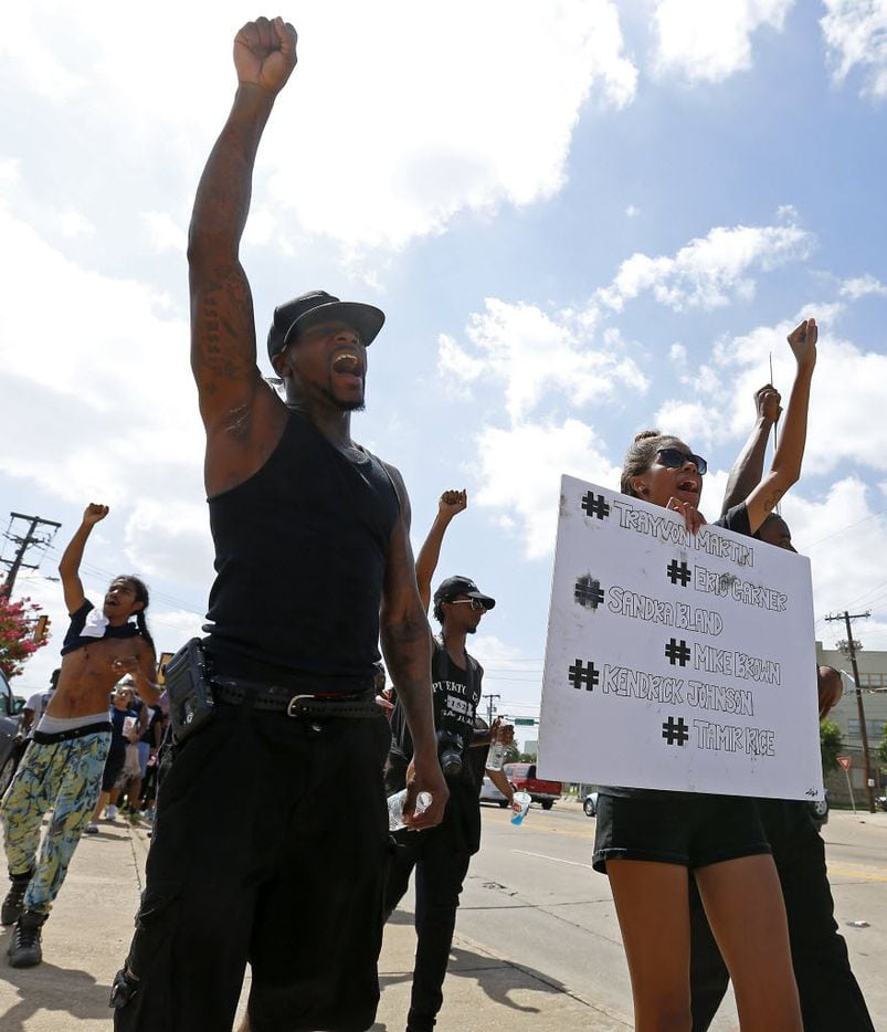 People protest at a Black Lives Matter rally on Park Lane in Dallas, Sunday, July 10, 2016....