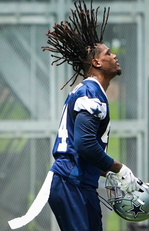 Dallas Cowboys defensive end Randy Gregory (94) tosses his hair back as he puts on his helmet between drills during a minicamp practice at The Star on Tuesday, June 8, 2021, in Frisco. (Smiley N. Pool/The Dallas Morning News)
