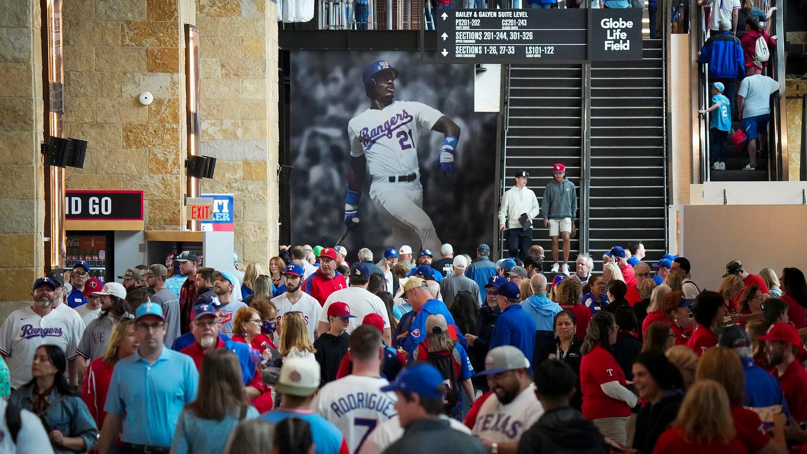 Fans stream into the stadium before the Texas Rangers opening day game against the...
