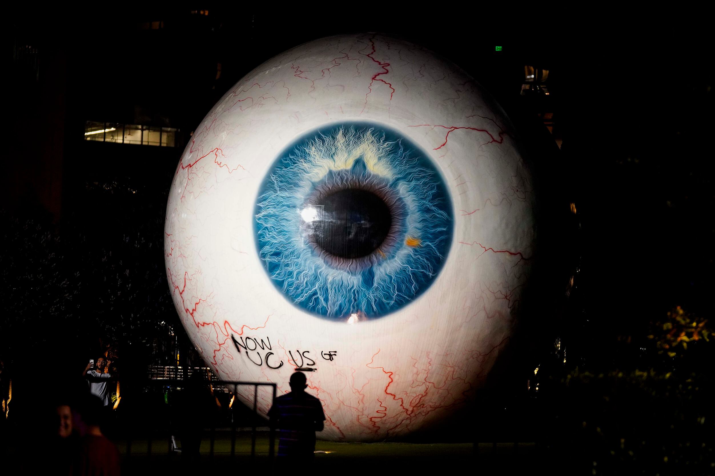 Graffiti is seen on the giant eyeball sculpture, titled" Eye," following a protest against...
