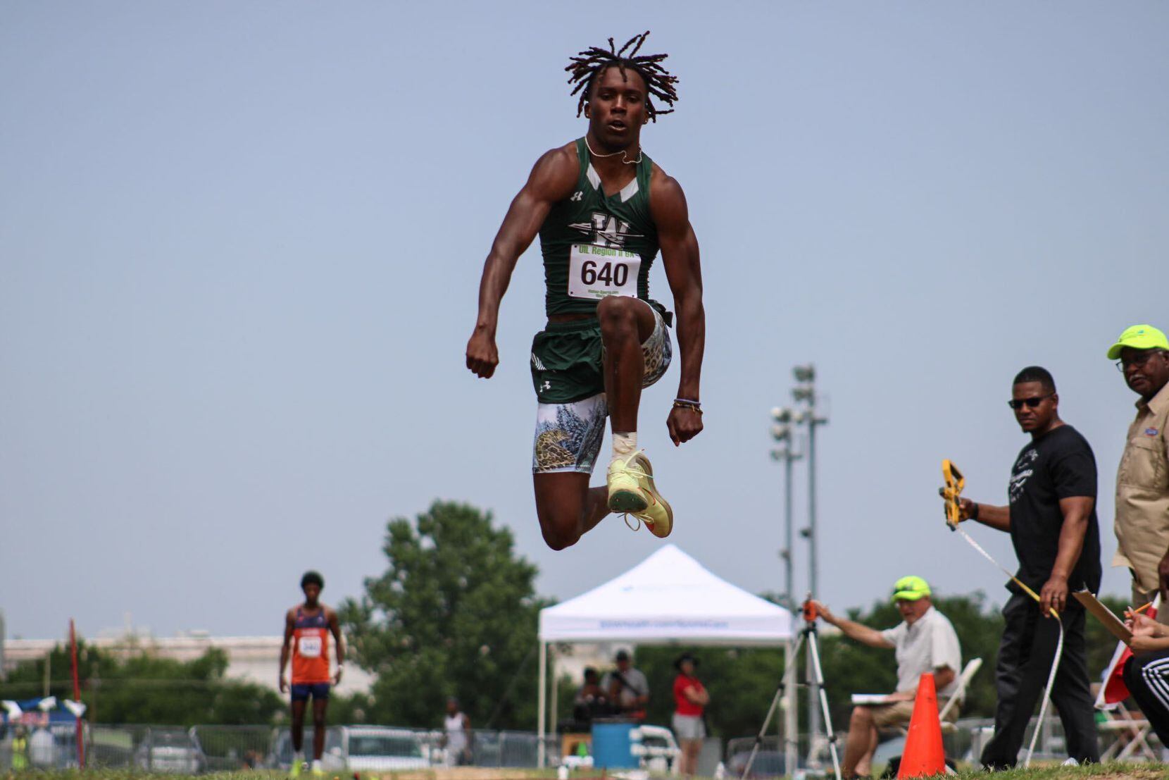 Waxahachie senior Jaylon Burke competes in the triple jump at the 6A Region II track and...