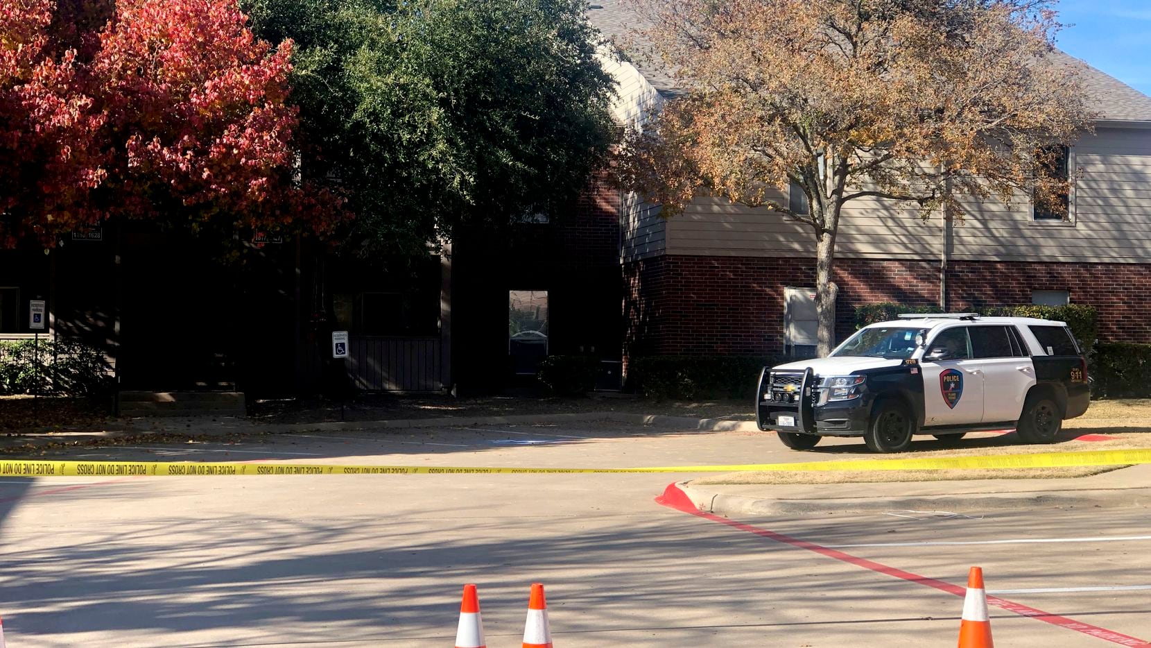 Police tape blocked off an apartment building in the 2300 block of Pebble Vale Drive, where...