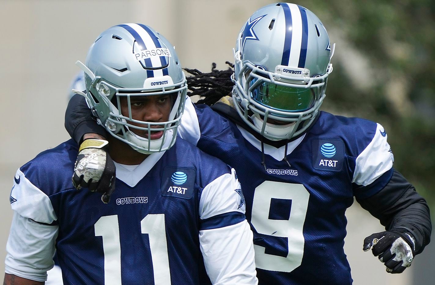Dallas Cowboys linebacker Jaylon Smith (9) puts an arm around linebacker Micah Parsons (11) during a minicamp practice at The Star on Tuesday, June 8, 2021, in Frisco. (Smiley N. Pool/The Dallas Morning News)