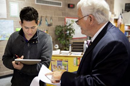 Jose Bermudez (left) talks with Bill Betzen as he picks up a time capsule letter at Raul...