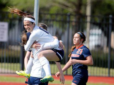 Highland Park's Presley Echols (10), jumps into the arms of teammate Rachel Wasserman after...