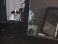 A shattered mirror inside Hair World Salon on Thursday, May 12, 2022 in Dallas. Police are...