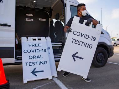 Juan Pérez, medical assistant at WellHealth, unloads signs announcing free COVID tests in the parking lot of Sharing Life Community Outreach in Mesquite on Tuesday, October 20, 2020.