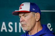 Texas Rangers manager Bruce Bochy listens to a question from a reporter during practice at...