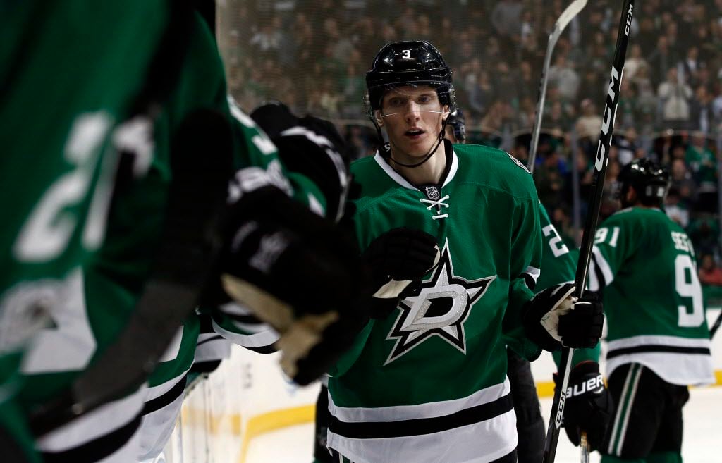 Dallas Stars' John Klingberg (3) is congratulated by teammates on the bench after scoring...