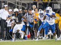 Central Florida running back Johnny Richardson (0) breaks away on a long run as SMU players,...