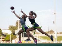 Syndel Murillo, 16, left, and Shale Harris, 15, reach for a pass as they try out for the...