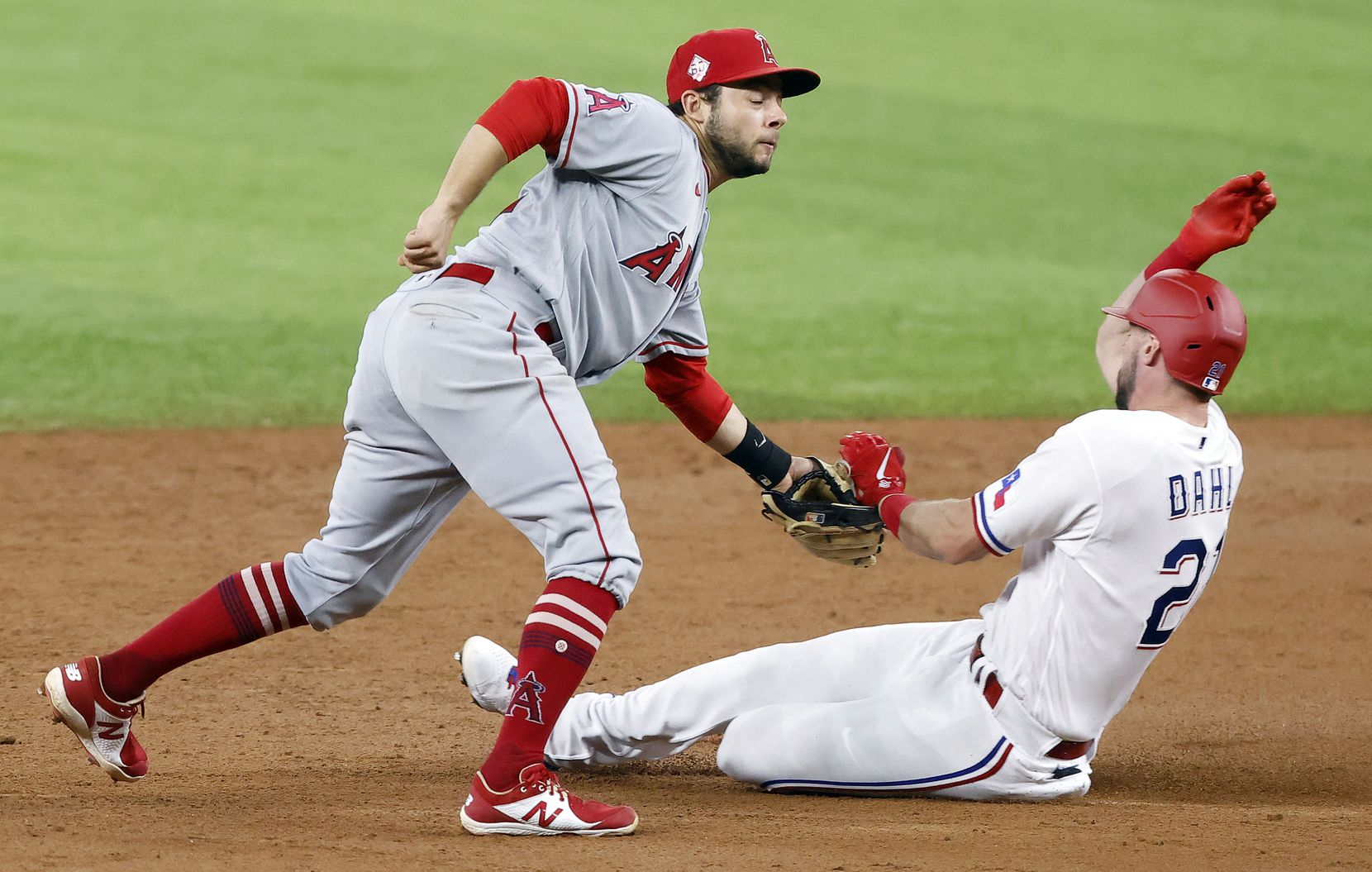 Texas Rangers left fielder David Dahl (21) is tagged on the hand tby Los Angeles Angels second baseman David Fletcher (22) trying to steal during the third inning at Globe Life Field in Arlington, Texas, Wednesday, April  28, 2021. (Tom Fox/The Dallas Morning News)