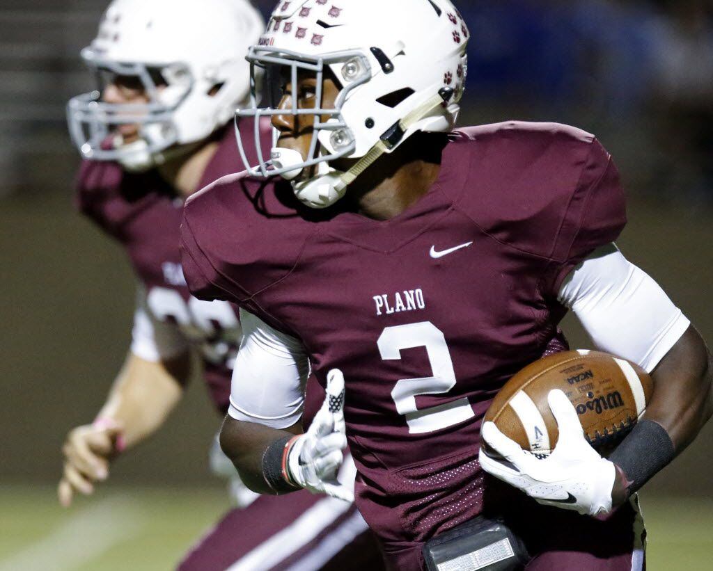 Plano High School running back Brandon Stephens (2) looks for room to run in the first...