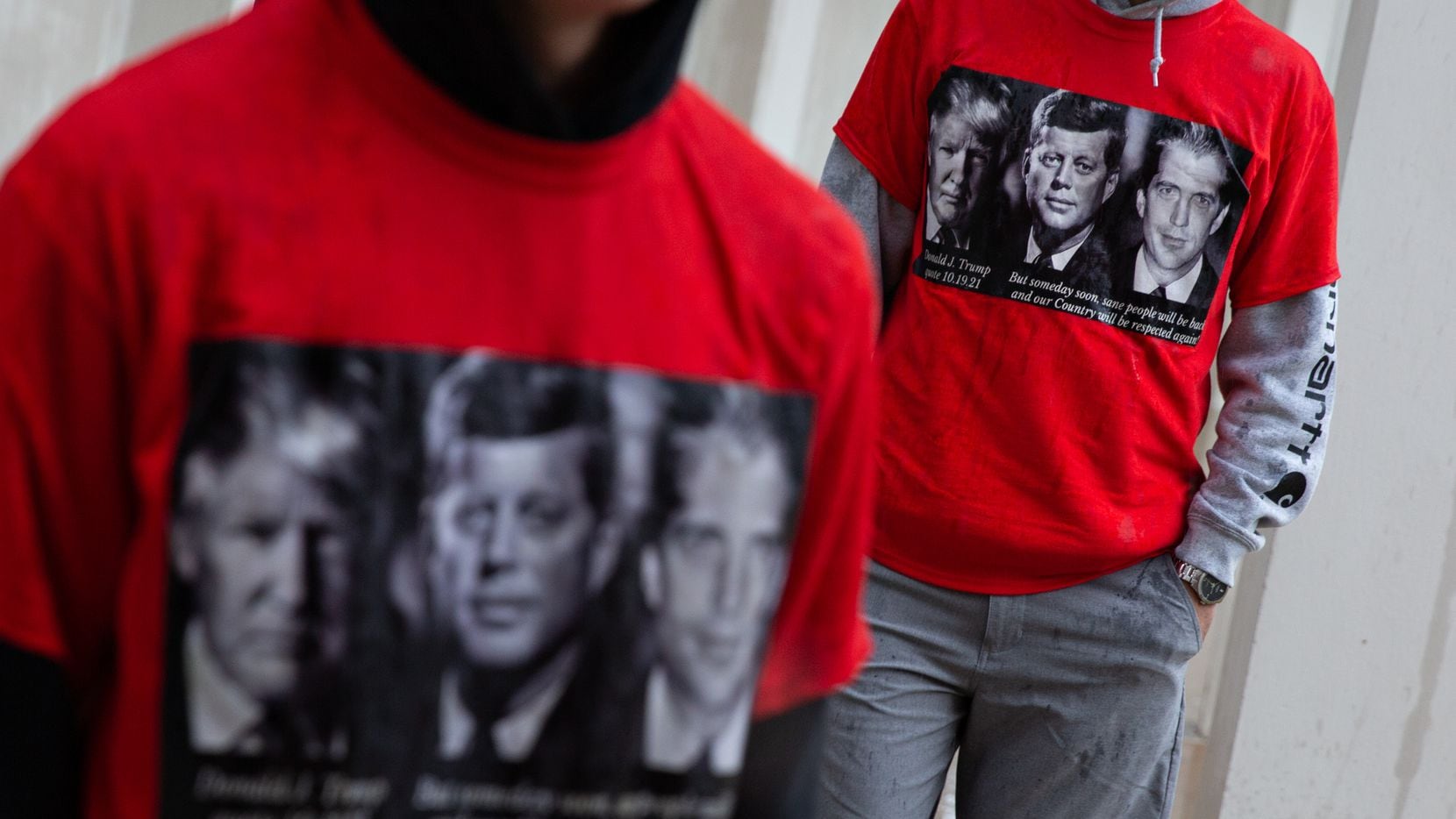 QAnon believers wear shirts with Donald Trump, John F. Kennedy, and John F. Kennedy Jr. at a...