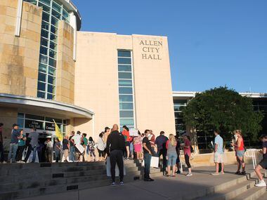 Allen ISD parents gather outside city hall for the Allen ISD board of trustees meeting on...