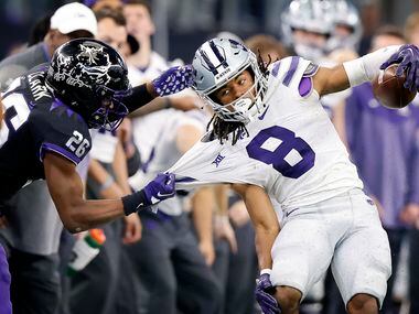 Kansas State Wildcats wide receiver Phillip Brooks (8) is pulled out of bounds by TCU Horned...