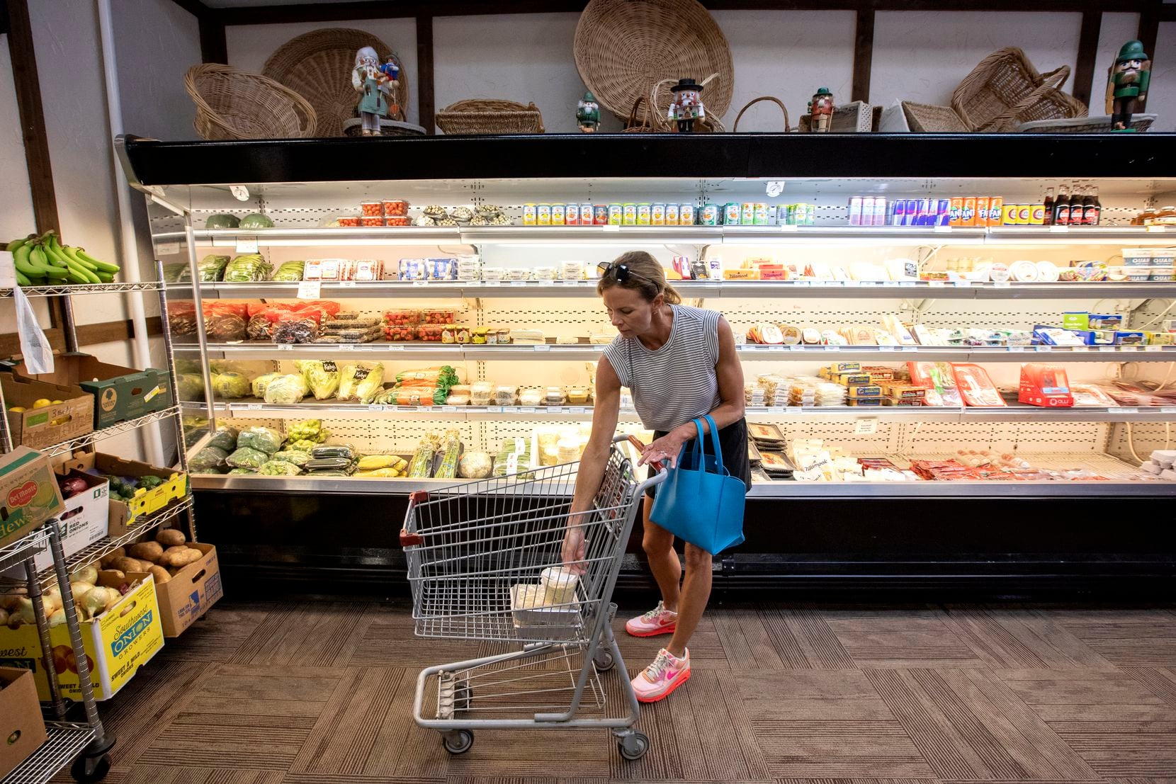 Kristi Pierce of University Park puts groceries into her cart at Kuby's Sausage House and...