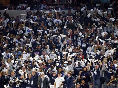 Dallas Cowboys fans cheer during the second half of an NFL football game against the Arizona Cardinals Jan. 2 at AT&T Stadium.