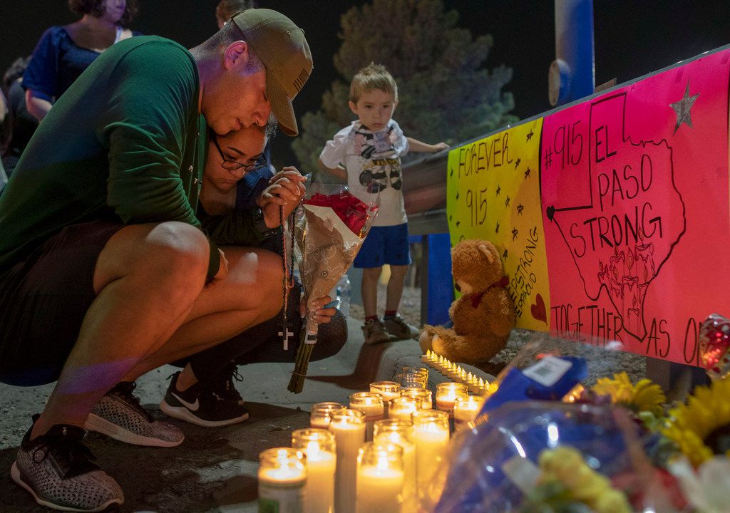 Rene Aguilar and Jackie Flores pray at a makeshift memorial on Aug. 4 for the victims of the mass shooting in El Paso on Aug. 3. The largely Hispanic city of El Paso has deep roots in Catholicism and religion in general. After the massacre that left 22 dead and two dozen injured, residents are turning to their faith to get through these times. 