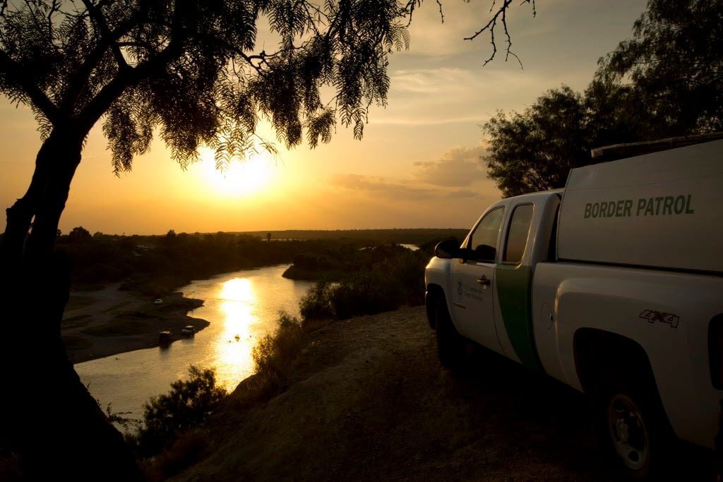  A U.S. Border Patrol agent keeps watch in Roma, which is across the Rio Grande River from Ciudad Miguel Aleman, Tamaulipas, Mexico. 