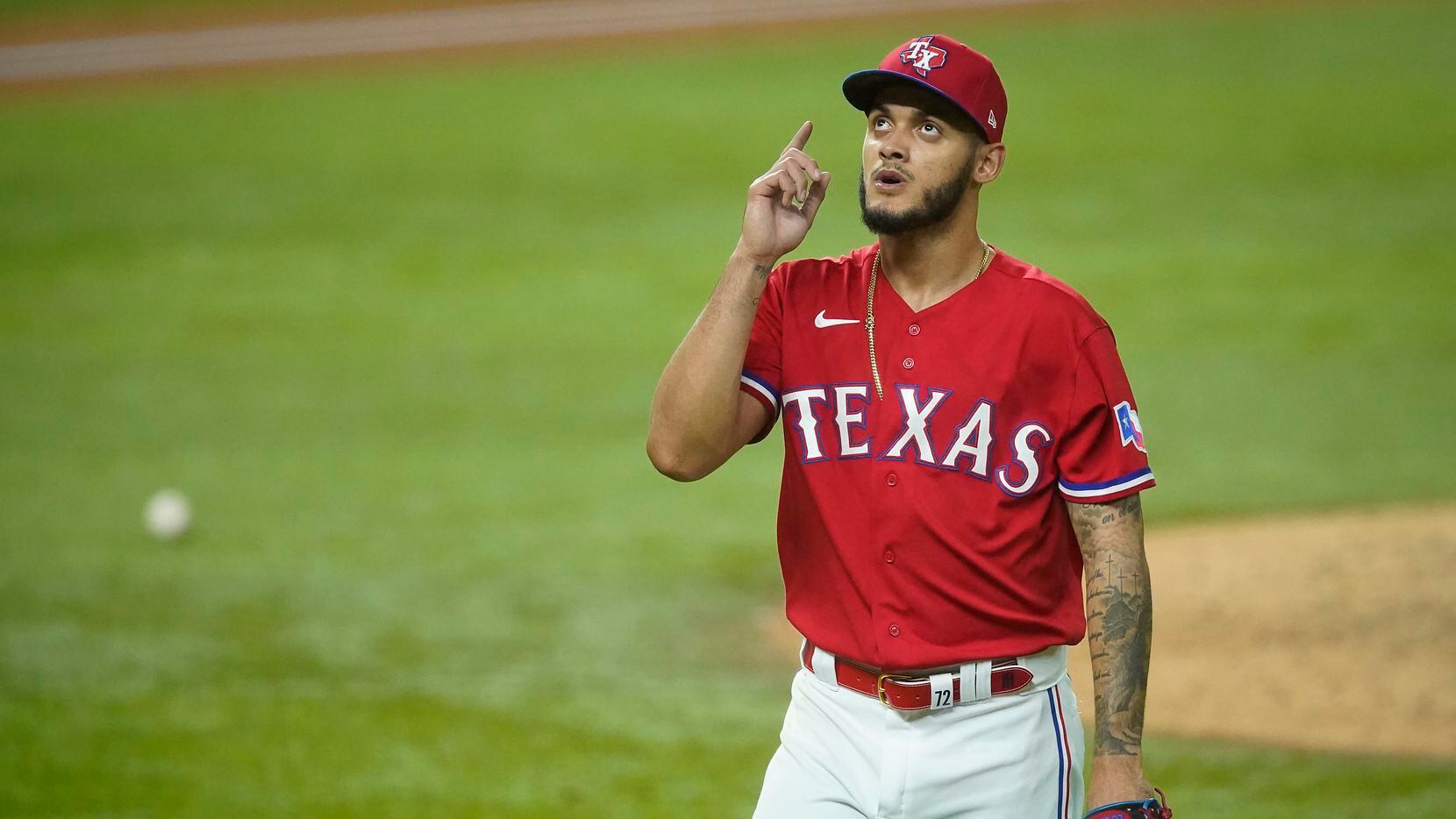 Texas Rangers pitcher Jonathan Hernandez heads for the dugout after giving up one run to the...