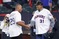 Former Texas Rangers third baseman Adrián Beltré shakes hands with former pitcher Fergie...