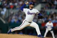 Texas Rangers starting pitcher Dane Dunning (33) delivers a pitch during the third inning...