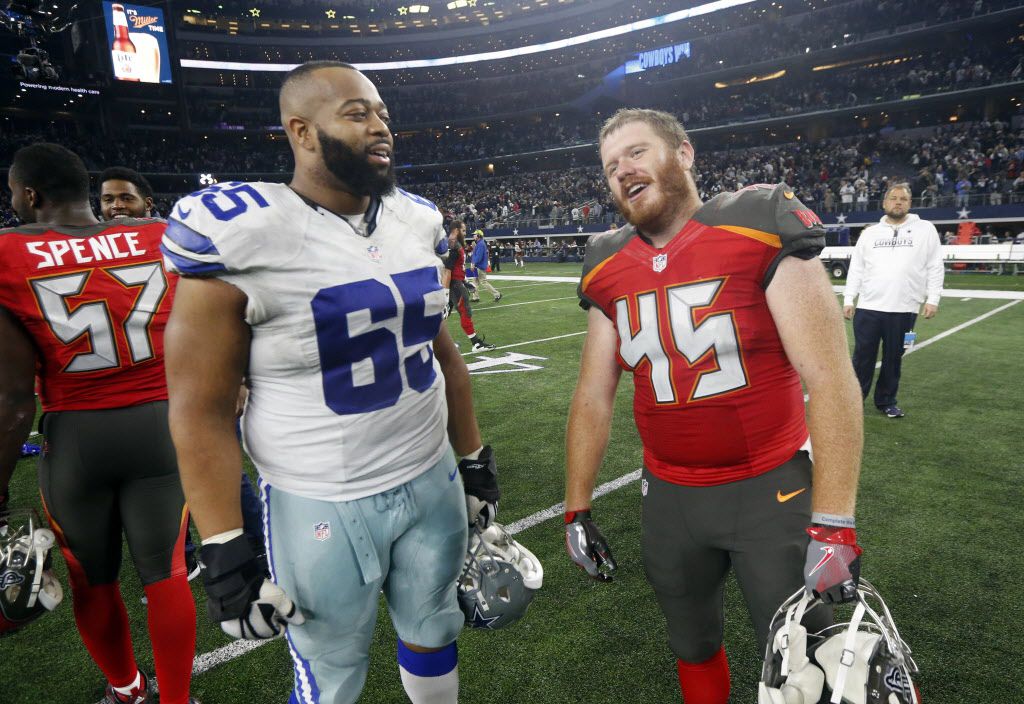 Dallas Cowboys' Ronald Leary (65) and Tampa Bay Buccaneers' Alan Cross (45) talk after their NFL football game, Sunday, Dec. 18, 2016, in Arlington, Texas. (AP Photo/Michael Ainsworth)