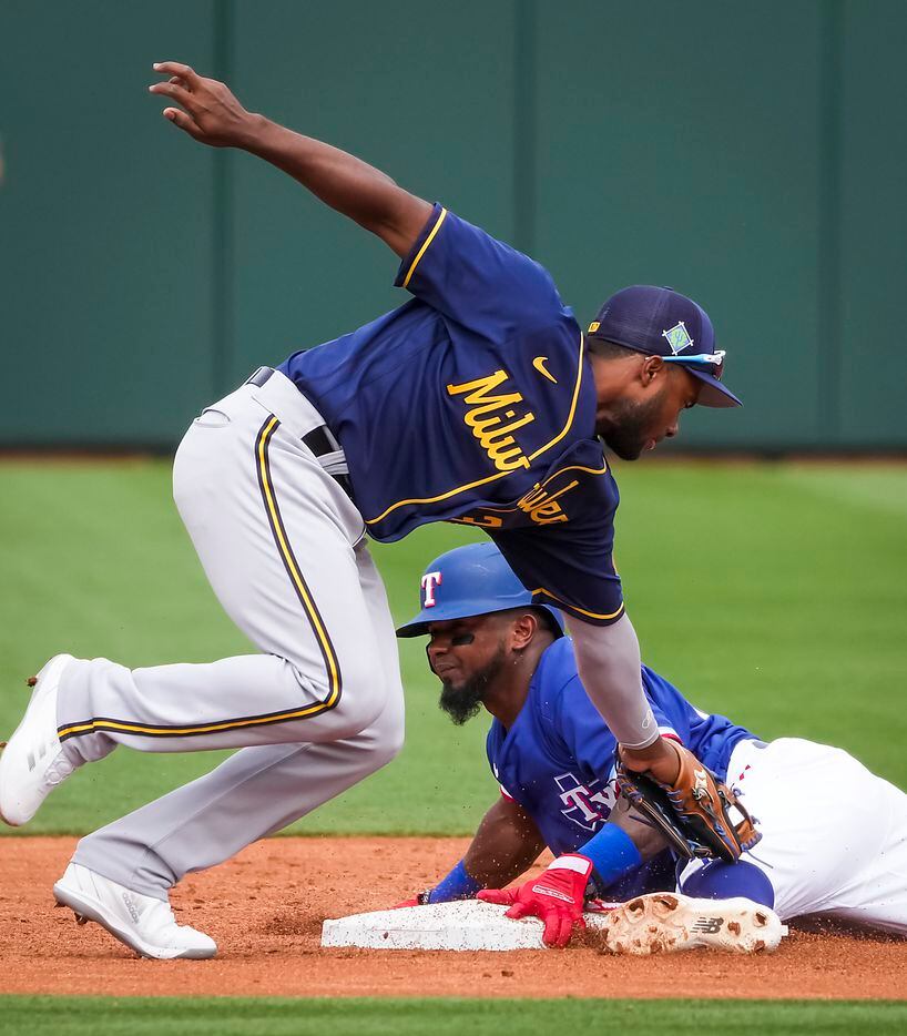 Texas Rangers shortstop Yonny Hernandez is safe at second base with a stolen base ahead of...