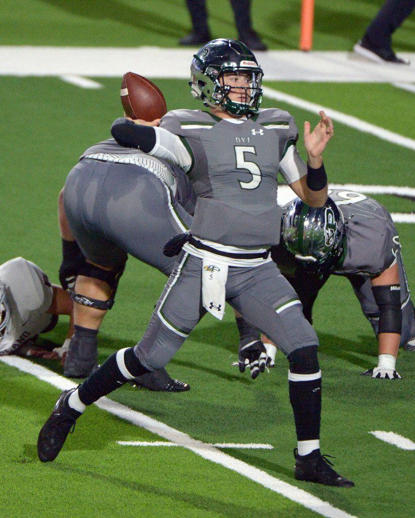 Prosper's Jackson Berry (5) looks to pass in the first half of a high school football game...