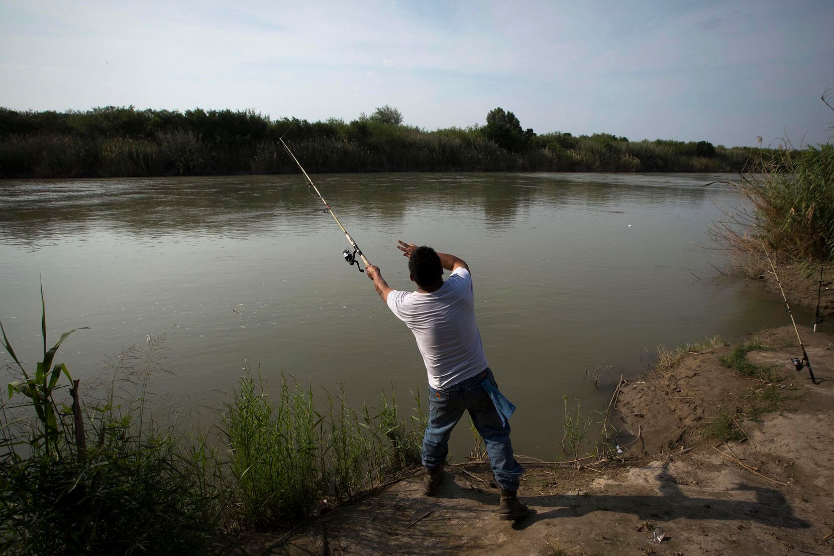 Leo Ayala of Laredo, Texas, casts a line into the Rio Grande River while fishing on May 10,...