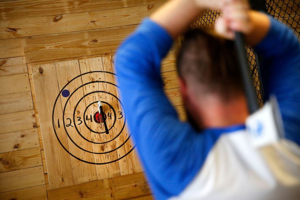 Anthony McGacock, operations manager, demonstrates ax throwing at Bad Axe Throwing in Dallas...