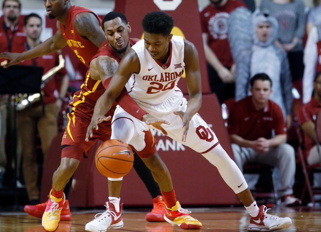 Iowa State guard Monte Morris, left, reaches in to knock the ball away from Oklahoma State...