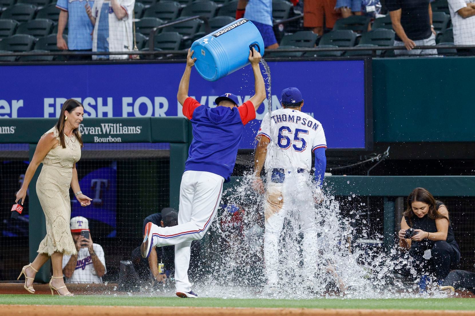 Texas Rangers starting pitcher Dane Dunning (33) dumps a cool of ice water on Texas Rangers...