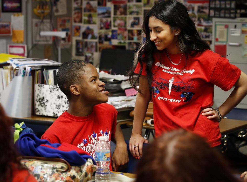 Damian Jordan and Lilibeth Ramirez talk during a Duncanville Sparklers team meeting at Duncanville High School. The Sparklers are a cheer squad for students with disabilities. (Staff Photo)