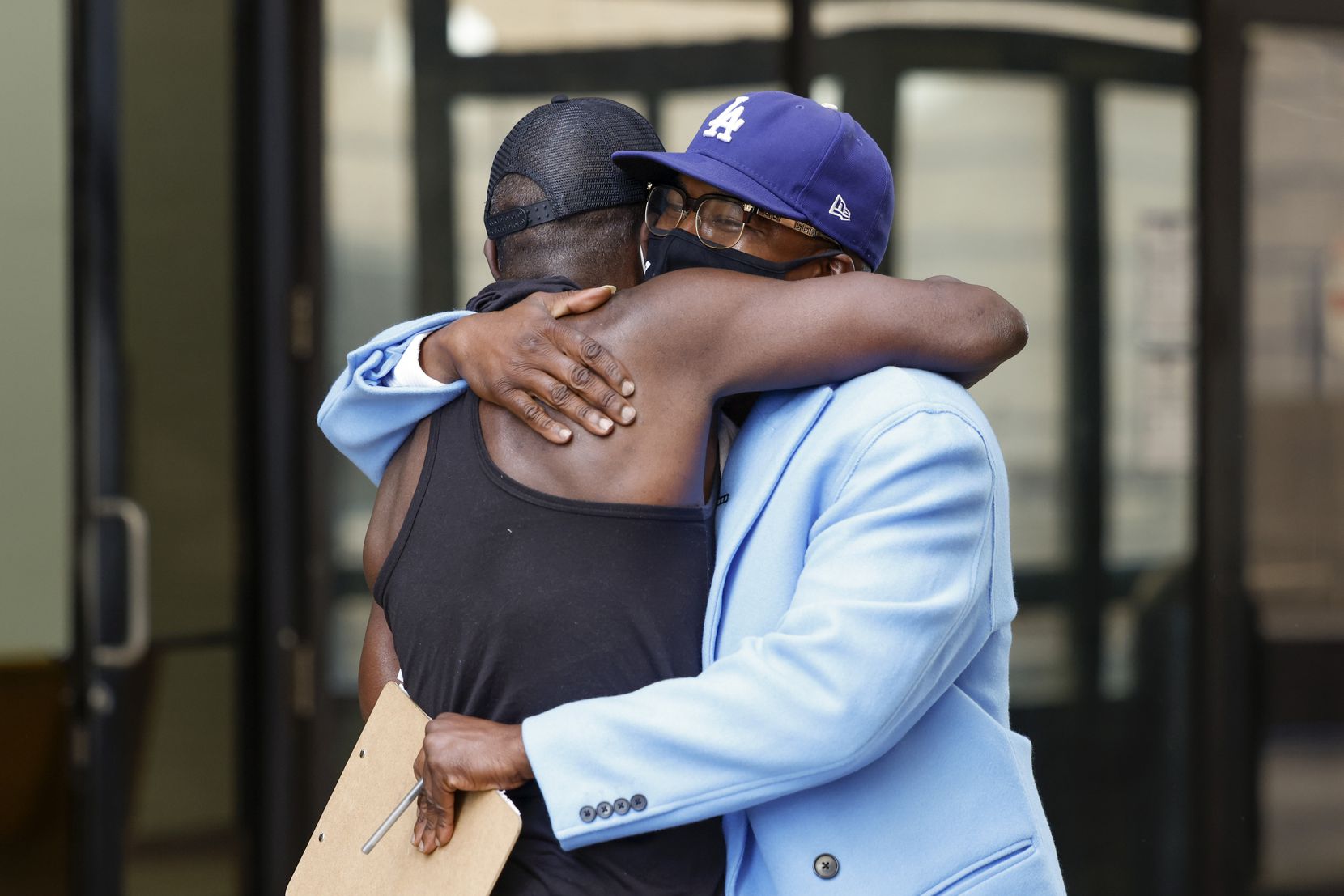 Mark Walters Jr., Luke 4:18 Bail Fund lead organizer (right), embraces Willy Mcnealy after he was released at the Lew Sterrett Justice Center in Dallas on Thursday. Mcnealy said it was indescribable how he felt after learning his bail had been paid by Faith in Texas’ Luke 4:18 Bail Fund. 