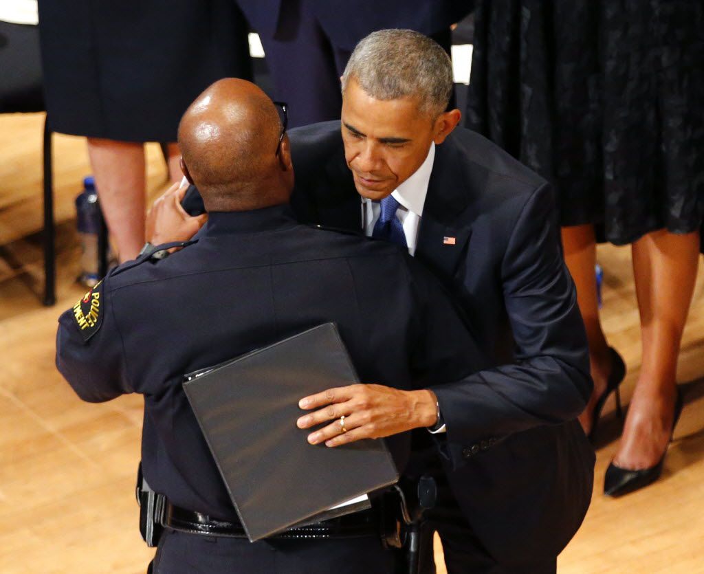 President Barack Obama hugs Dallas police chief David Brown (left) after Brown's speech at an interfaith memorial service for 5 fallen officers at the Morton H. Meyerson Symphony Center in Dallas, Tuesday, July 12, 2016.  The Obamas were joined by Vice-President Joe Biden and his wife Jill Biden, former President George W. Bush and First Lady Laura Bush.  Four Dallas police officers and one DART officer were gunned down last week in downtown Dallas at a protest rally. (Tom Fox/The Dallas Morning News)