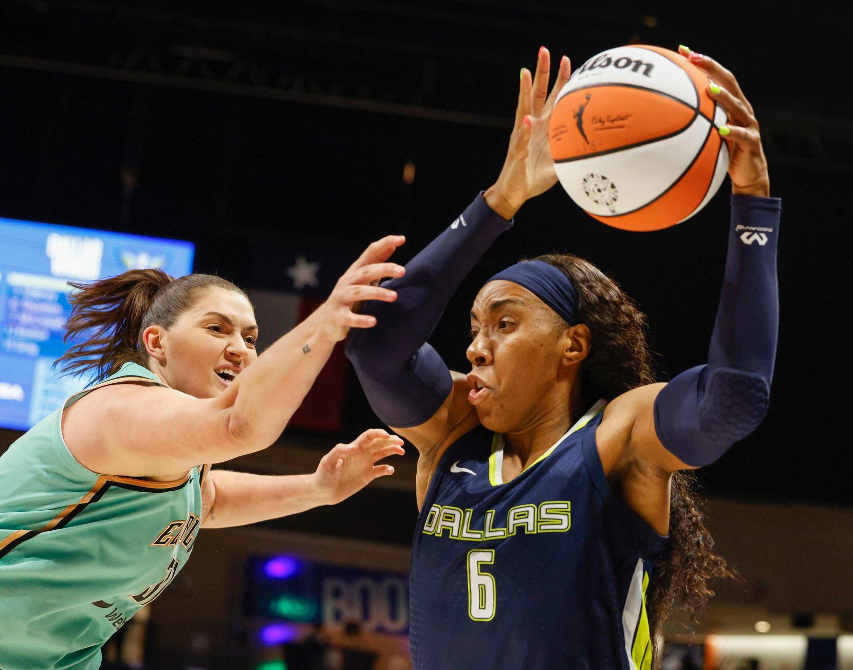 Dallas Wings forward Kayla Thornton (6) secures a rebound ahead of New York Liberty center...