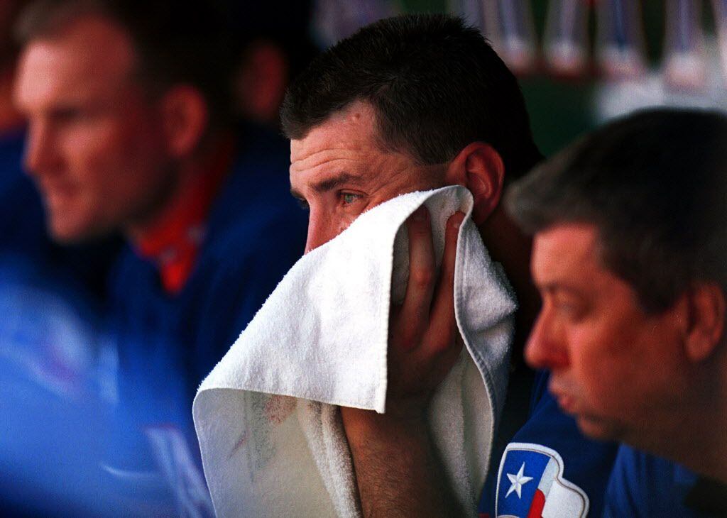 Texas Rangers starting pitcher Mark Clark buries his head in a towel in the second inning of...
