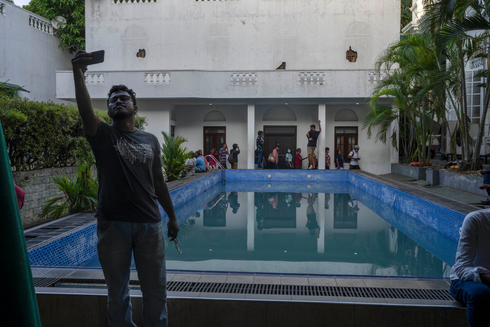 A man takes selfie at the swimmimg pool of the official residence of president Gotabaya...