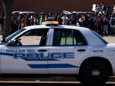Students at Moises E. Molina High School walk out of class and rally in the parking lot in...