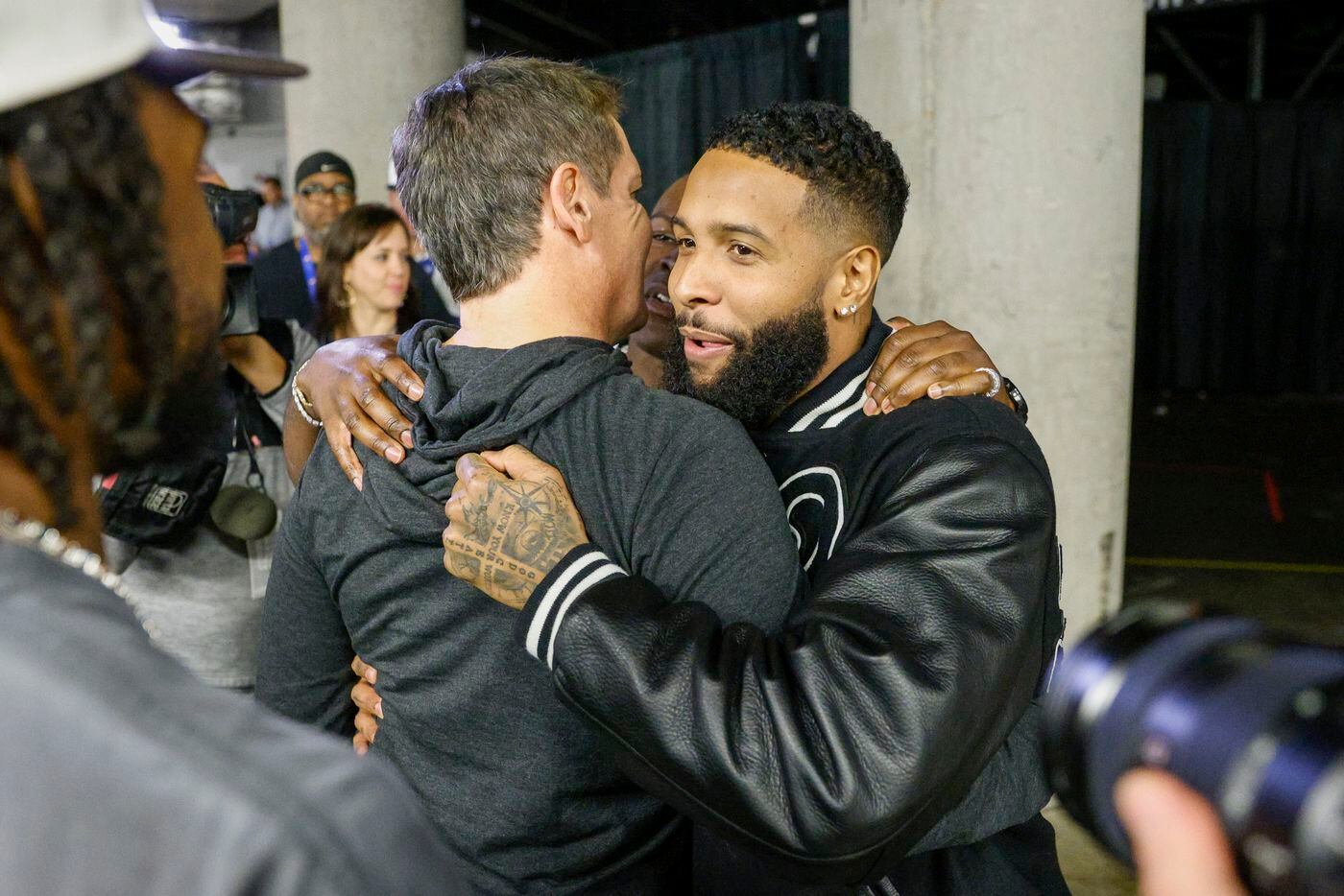 NFL free agent Odell Beckham Jr. (right) greets Dallas Mavericks owner Mark Cuban after an...