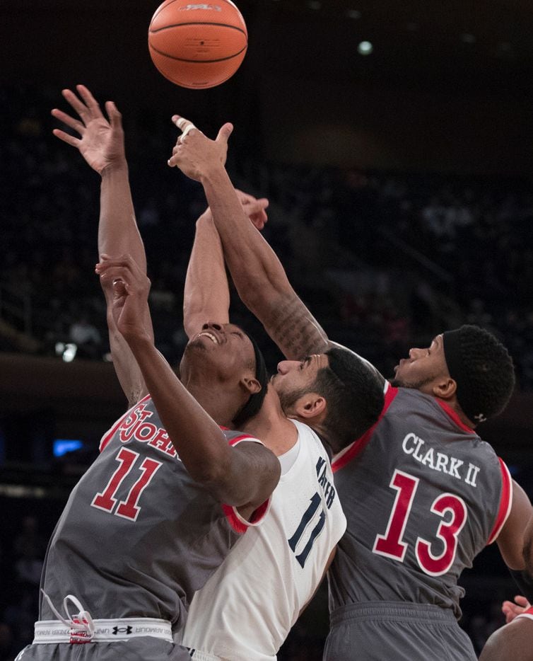St. John's forwards Tariq Owens (11) and Marvin Clark II (13) battle for the ball with...