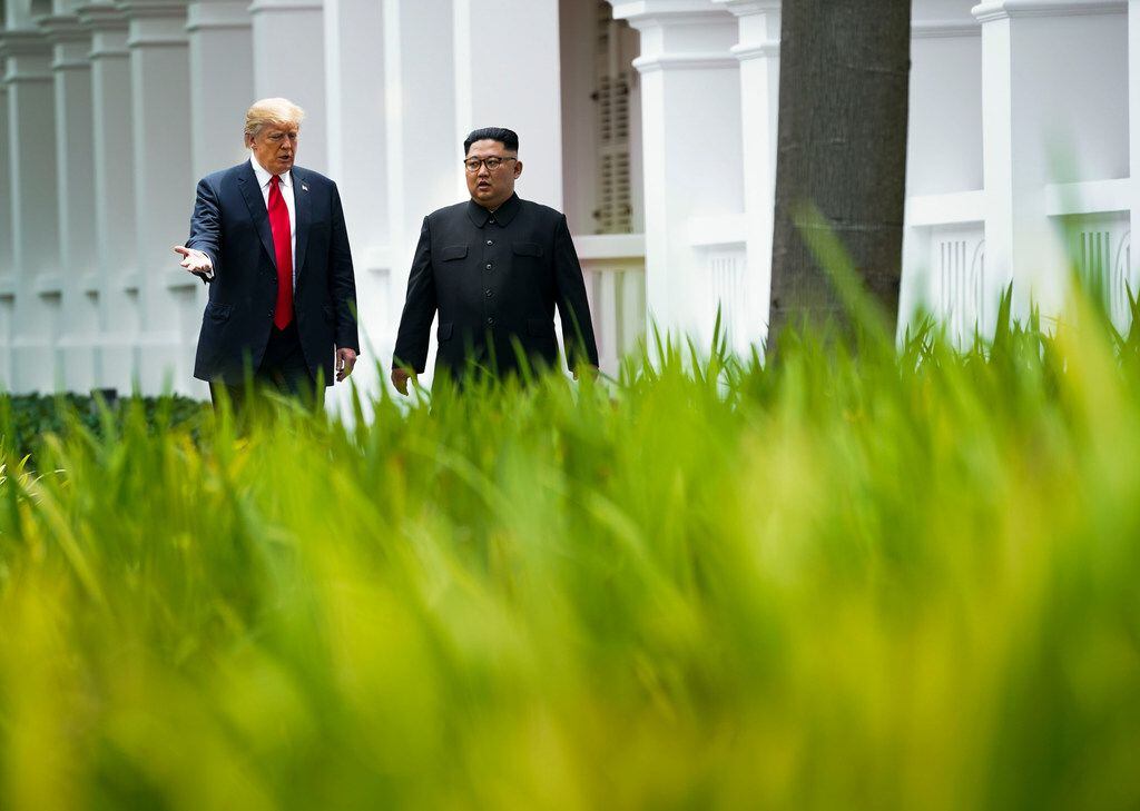 President Donald Trump and Kim Jong Un of North Korea take a walk after their lunch on...