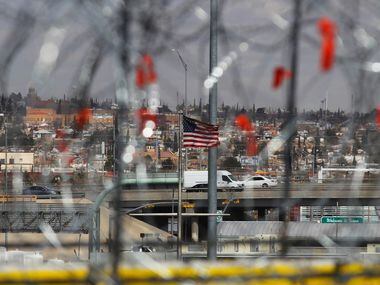 A U.S. flag flutters in the wind as barbed-wire barriers are being installed at the Zaragoza...